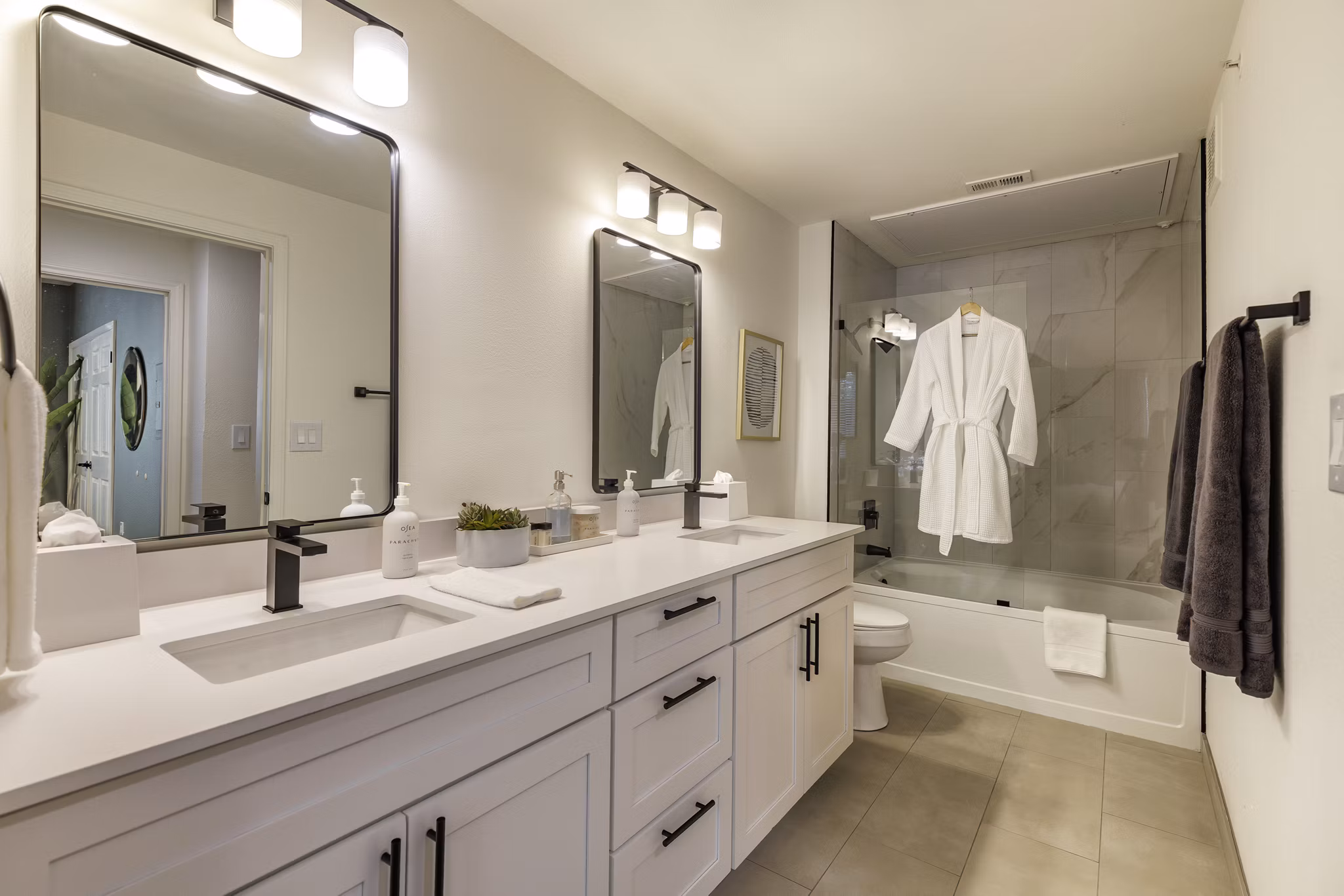 Modern bathroom featuring sleek fixtures and elegant tile design in The Lola Apartments