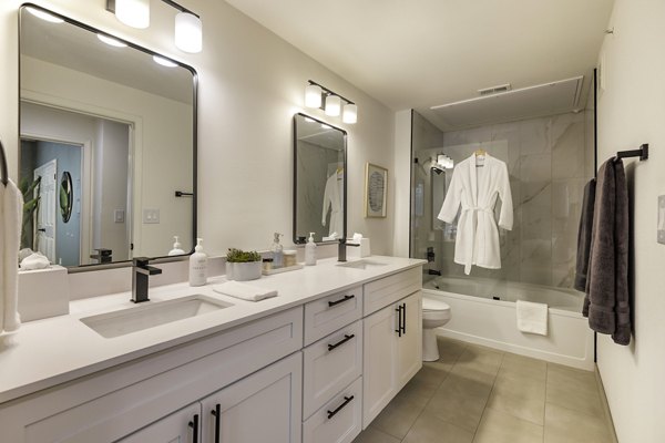 Modern bathroom featuring sleek fixtures and elegant tile design in The Lola Apartments