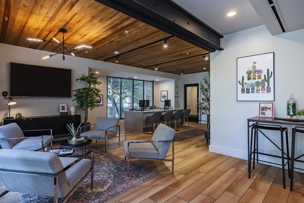 The Lola Apartments: Stylish clubhouse featuring modern decor and amenities in a luxury apartment community