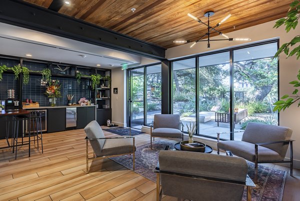 Clubhouse with modern decor and lounge seating at The Lola Apartments, a luxury property managed by Greystar