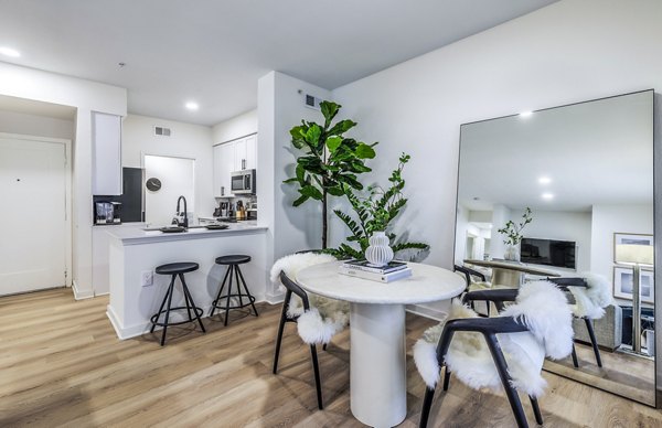 Dining area with modern furnishings and stylish lighting in The Lola Apartments