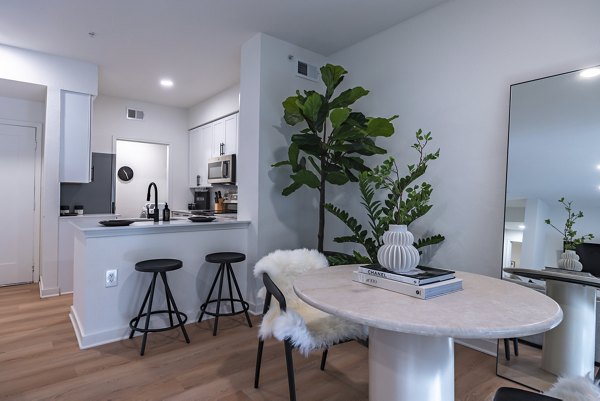 Dining area with elegant lighting and modern furnishings at The Lola Apartments