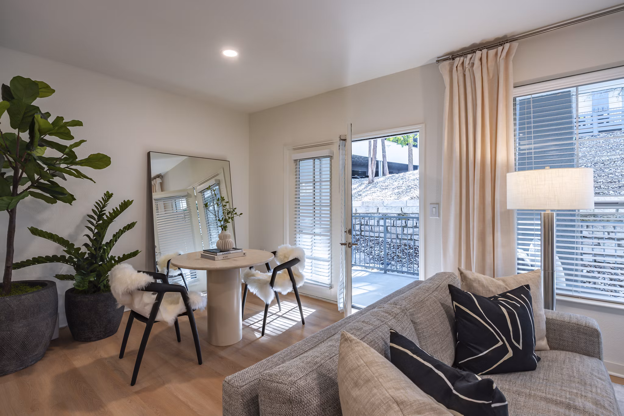 Dining room with sleek furnishings and modern lighting at The Lola Apartments