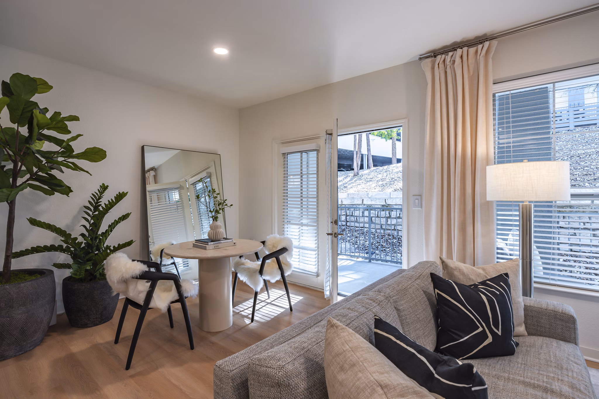 Dining room with sleek furnishings and modern lighting at The Lola Apartments