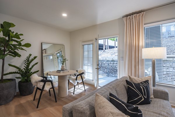 Dining room with sleek furnishings and modern lighting at The Lola Apartments