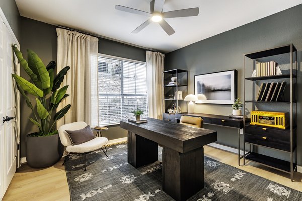 Modern home office with ergonomic desk and chair in The Lola Apartments, ideal for remote work in a luxury living environment