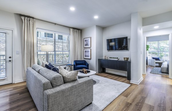 Spacious living room with contemporary furnishings in The Lola Apartments, a luxury community by Greystar