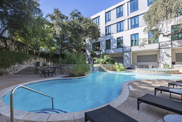 Rooftop pool with city skyline views at The Lola Apartments, a luxury Greystar property