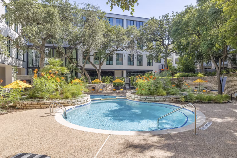 Sparkling swimming pool at The Lola Apartments offering luxury relaxation