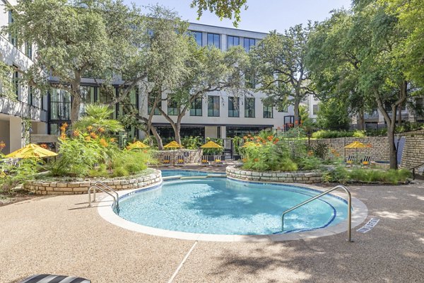 Sparkling swimming pool at The Lola Apartments offering luxury relaxation