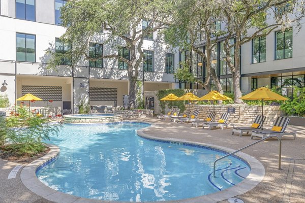 Sparkling outdoor pool at The Lola Apartments, luxury property with resort-style amenities