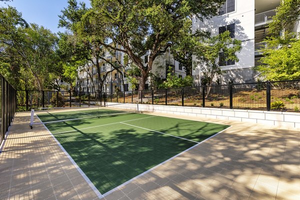 Sport court for residents at The Lola Apartments offering recreational space for basketball and tennis enthusiasts