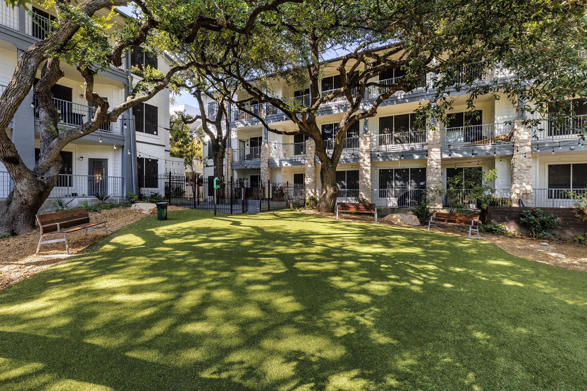 Modern dog park with agility equipment at The Lola Apartments for pet-friendly living