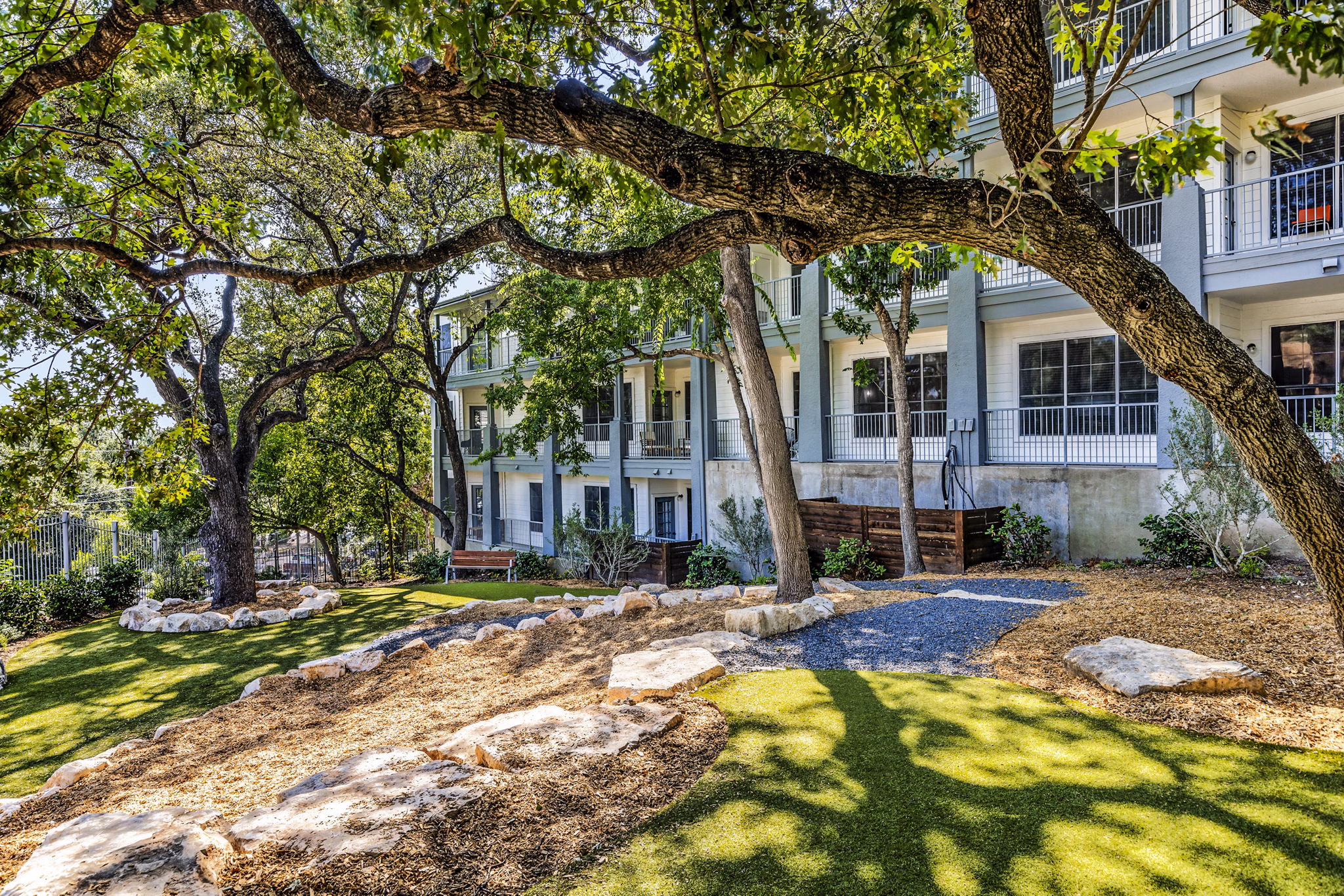 Dog park with agility equipment at The Lola Apartments, offering pet-friendly amenities for luxury living