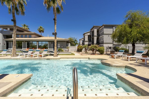 Expansive pool with lounge chairs at Gateway at Tempe Apartments, offering relaxation and luxury living in a vibrant community