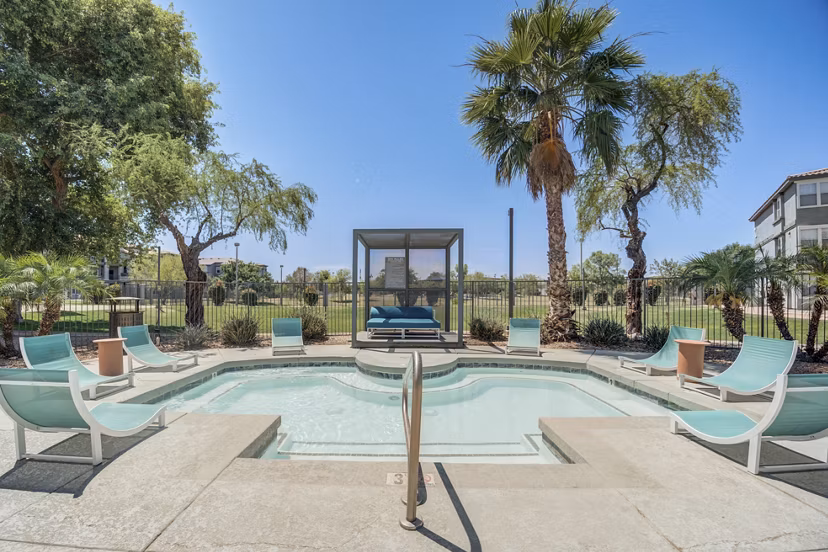 Pool with sleek lounge chairs at Gateway at Tempe Apartments