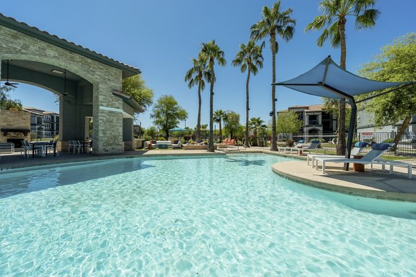 Pool with sleek lounge chairs at Gateway at Tempe Apartments