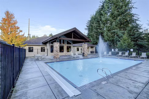 Outdoor pool with lounge chairs at The Dakota Apartments, luxury residence by Greystar