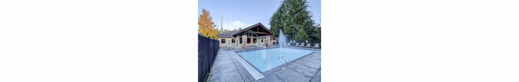 Outdoor pool with lounge chairs at The Dakota Apartments, luxury residence by Greystar