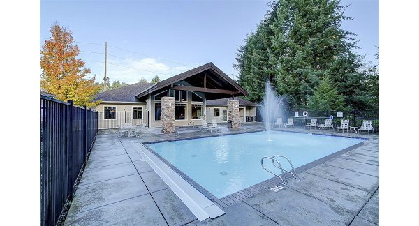Outdoor pool with lounge chairs at The Dakota Apartments, luxury residence by Greystar