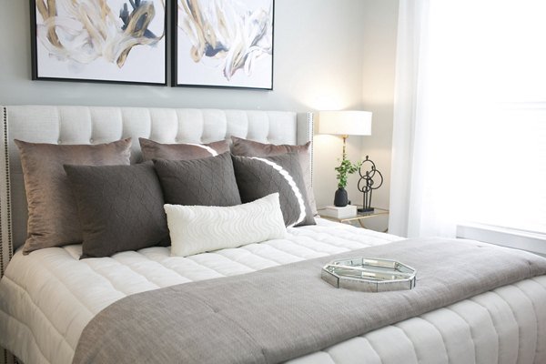 Modern bedroom with scenic views at The Peak at Nichols Plaza Apartments