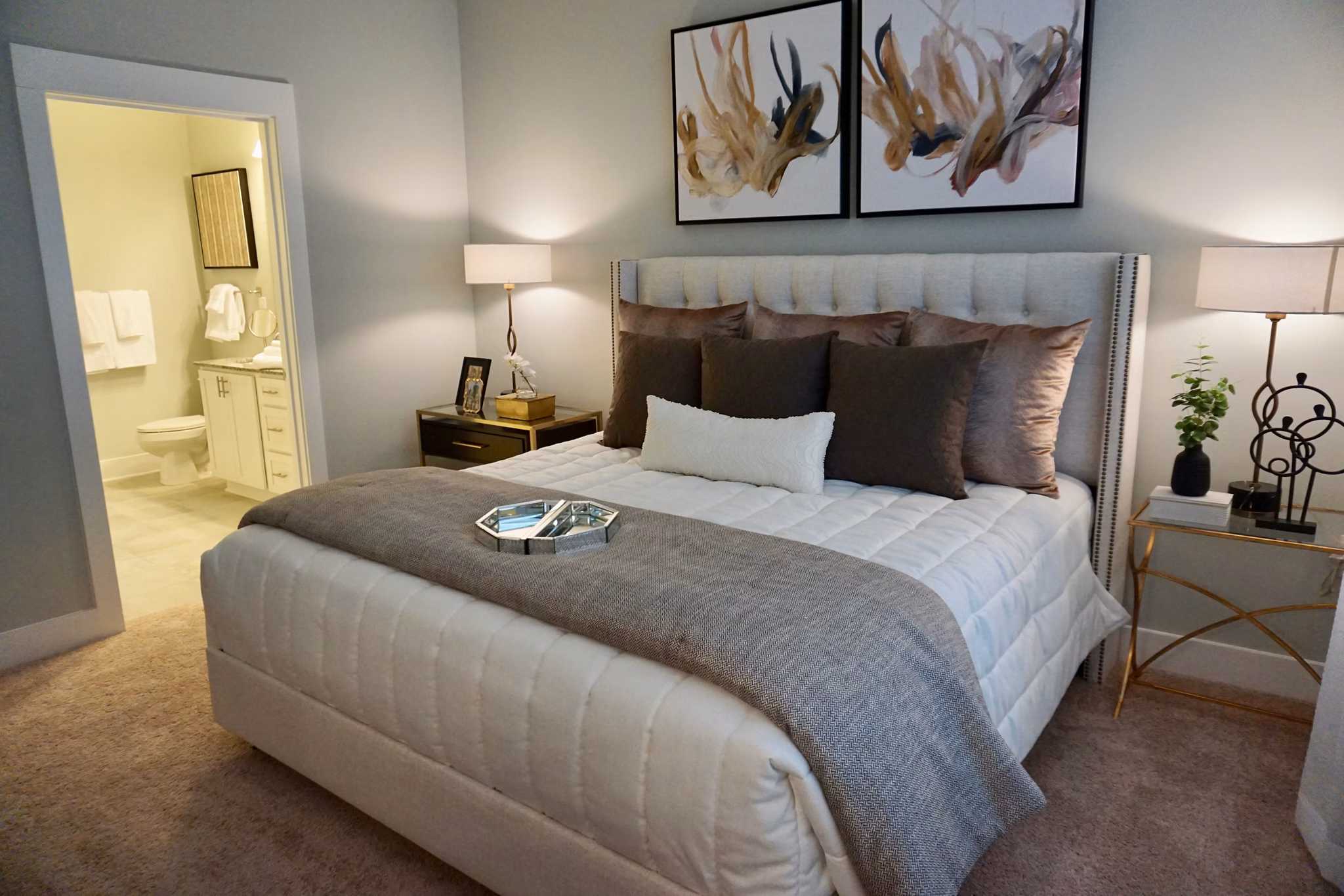 Bedroom featuring modern decor and plush bedding in The Peak at Nichols Plaza Apartments, a Greystar luxury community