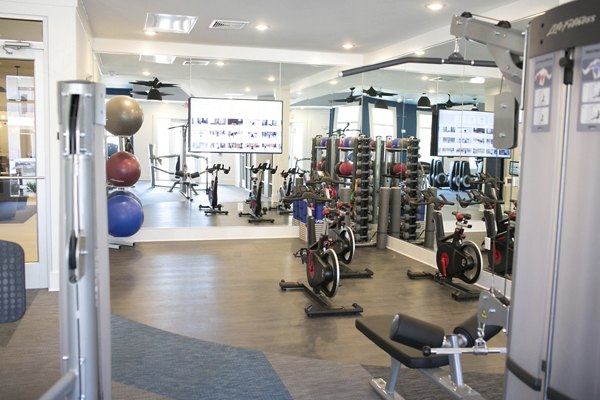 State-of-the-art fitness center with modern equipment at The Peak at Nichols Plaza Apartments