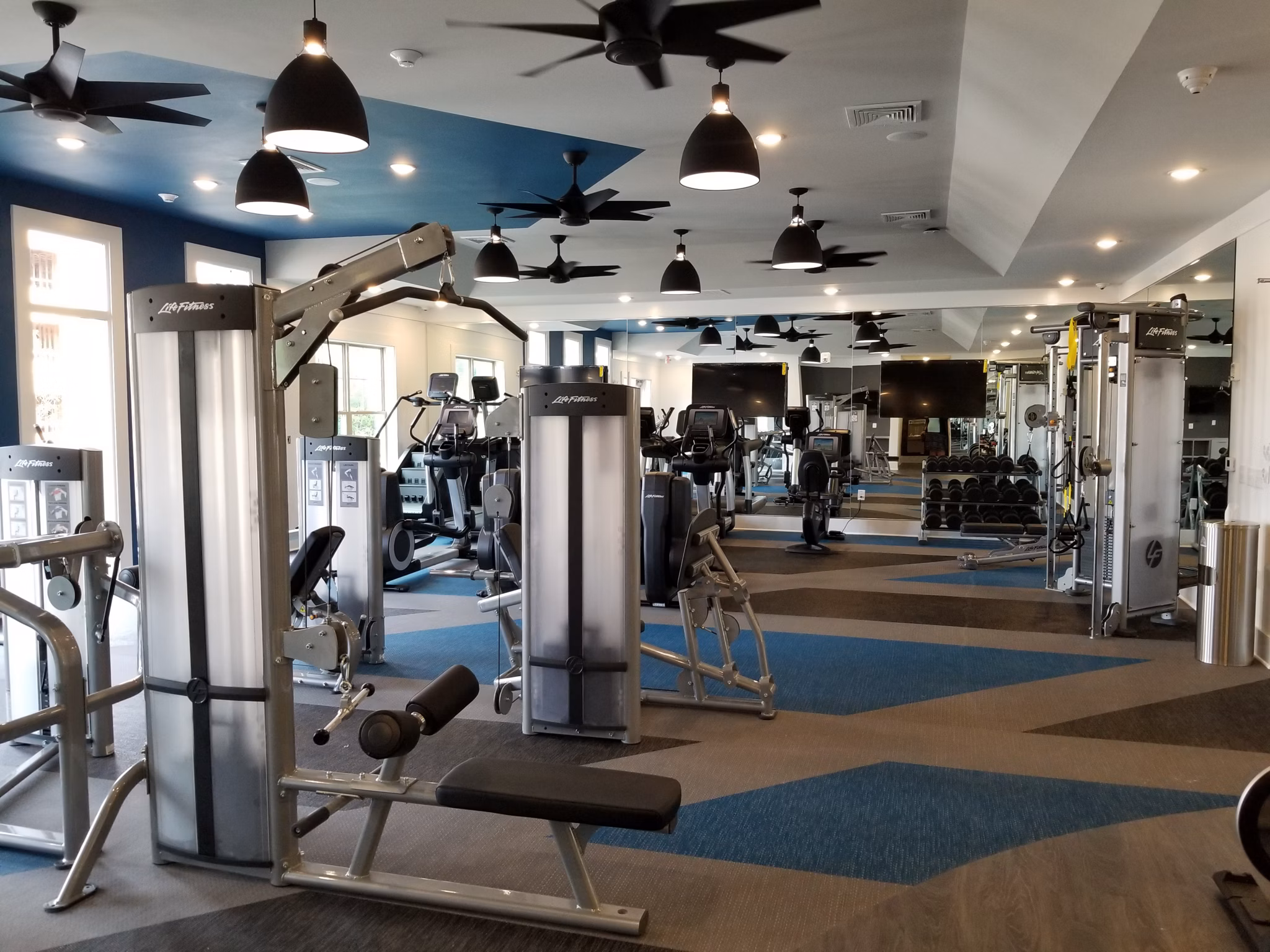 State-of-the-art fitness center with modern equipment at The Peak at Nichols Plaza Apartments