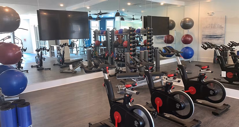 Modern fitness center with state-of-the-art equipment at The Peak at Nichols Plaza Apartments Perfect for maintaining an active lifestyle