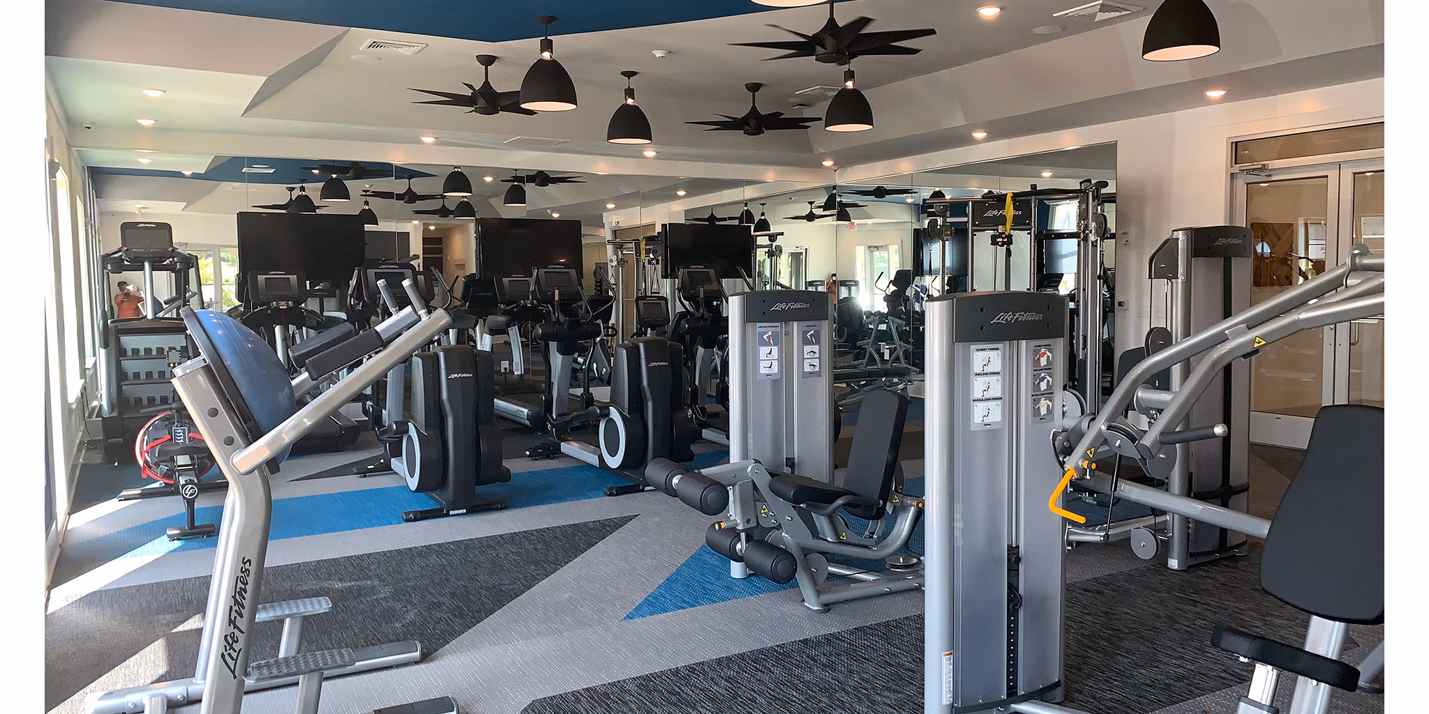 State-of-the-art fitness center with modern equipment at The Peak at Nichols Plaza Apartments Perfect for maintaining an active lifestyle