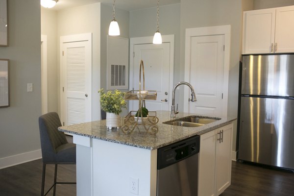 Contemporary kitchen with stainless steel appliances at The Peak at Nichols Plaza apartments in Greystar's luxury portfolio