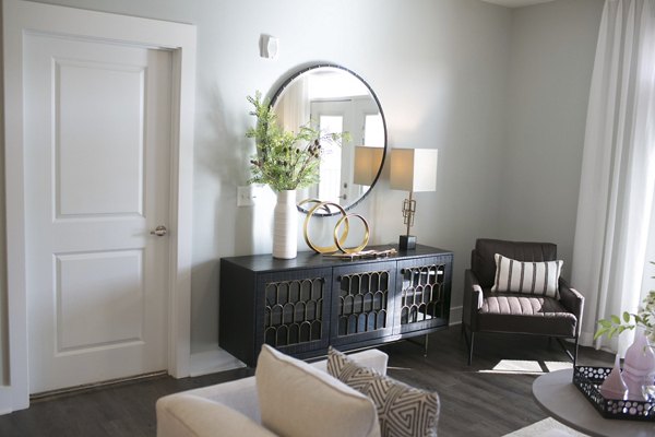 Spacious living room with modern decor at The Peak at Nichols Plaza Apartments