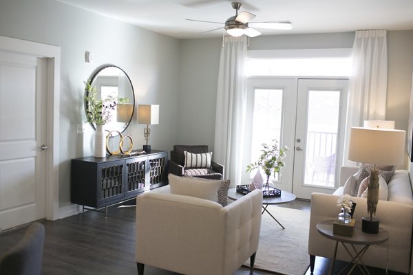 Spacious living room with modern furnishings at The Peak at Nichols Plaza Apartments