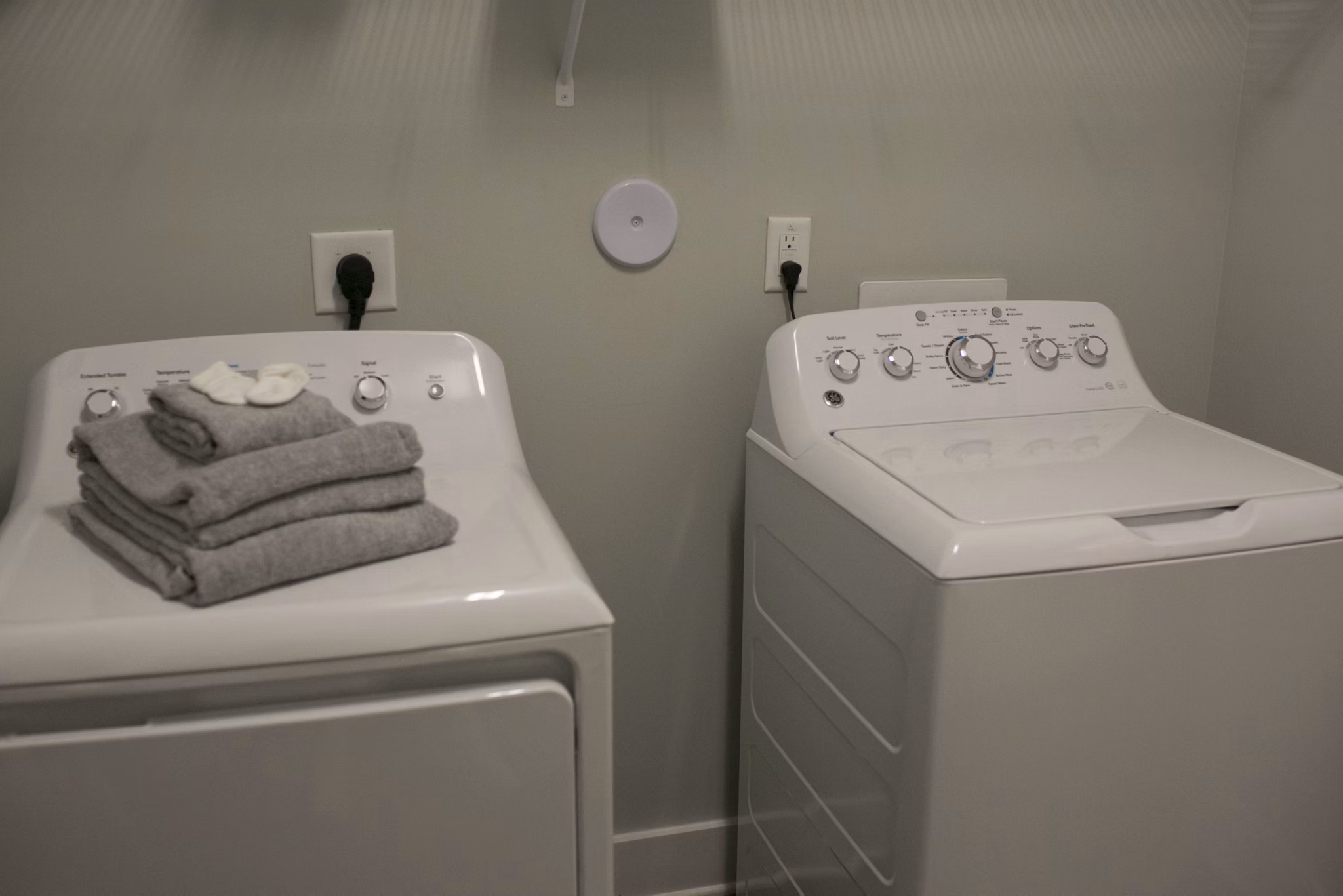 Laundry room with modern appliances at The Peak at Nichols Plaza Apartments
