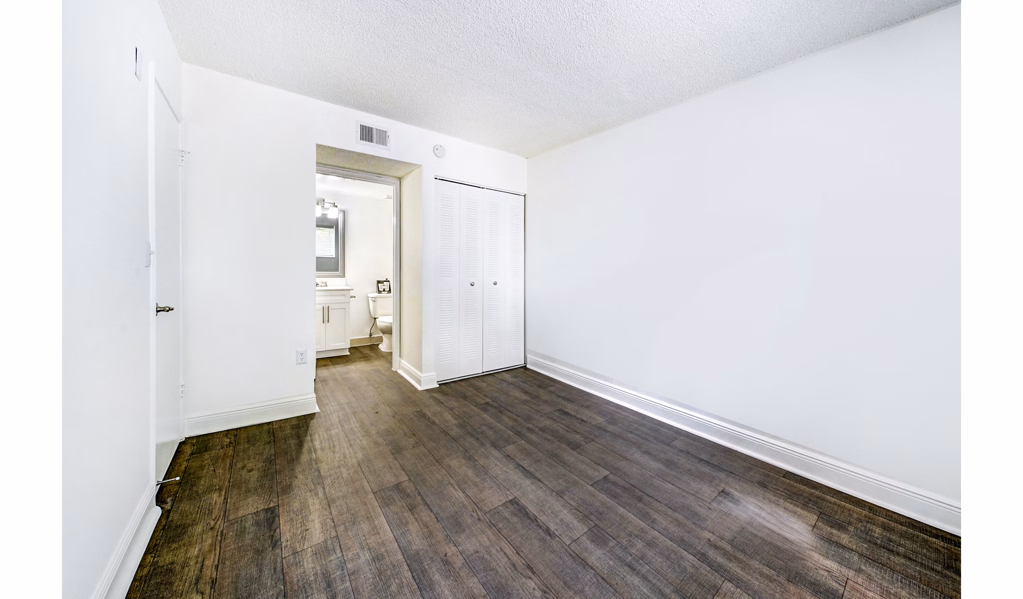 Cozy bedroom featuring modern design at 7 West Apartments, ideal for comfort and style in a luxury setting