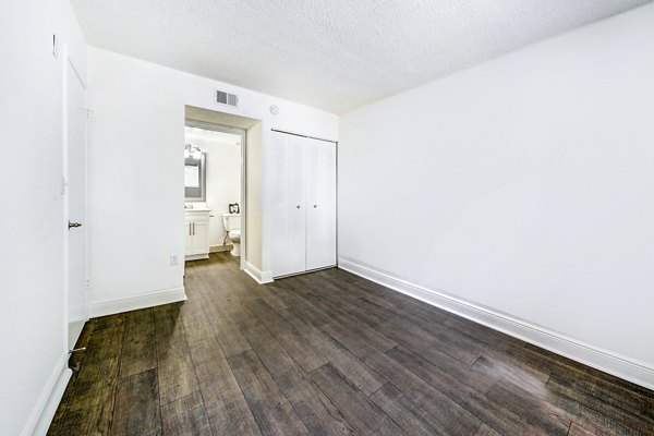 Cozy bedroom featuring modern design at 7 West Apartments, ideal for comfort and style in a luxury setting