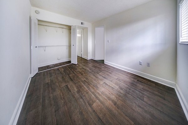 Cozy bedroom featuring modern decor and large windows in 7 West Apartments