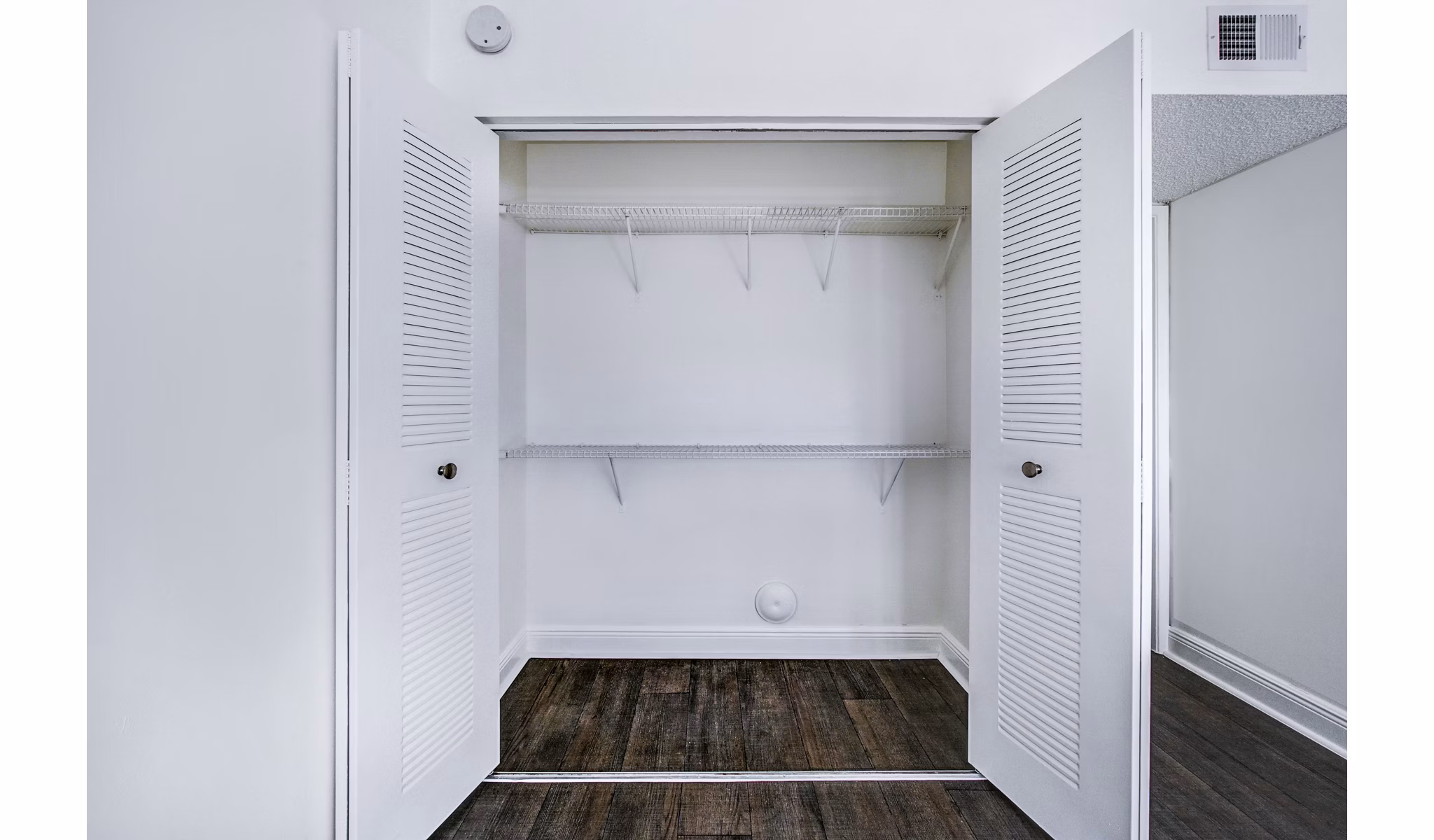 Spacious bedroom closet with built-in shelving in 7 West Apartments