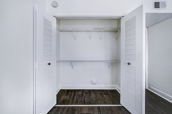 Spacious bedroom closet with built-in shelving in 7 West Apartments
