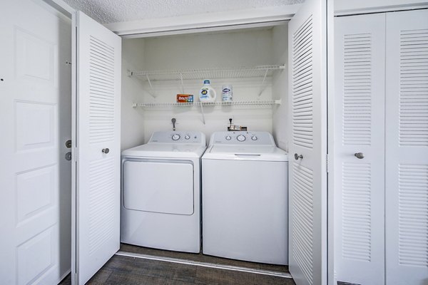 Laundry room with modern appliances at 7 West Apartments