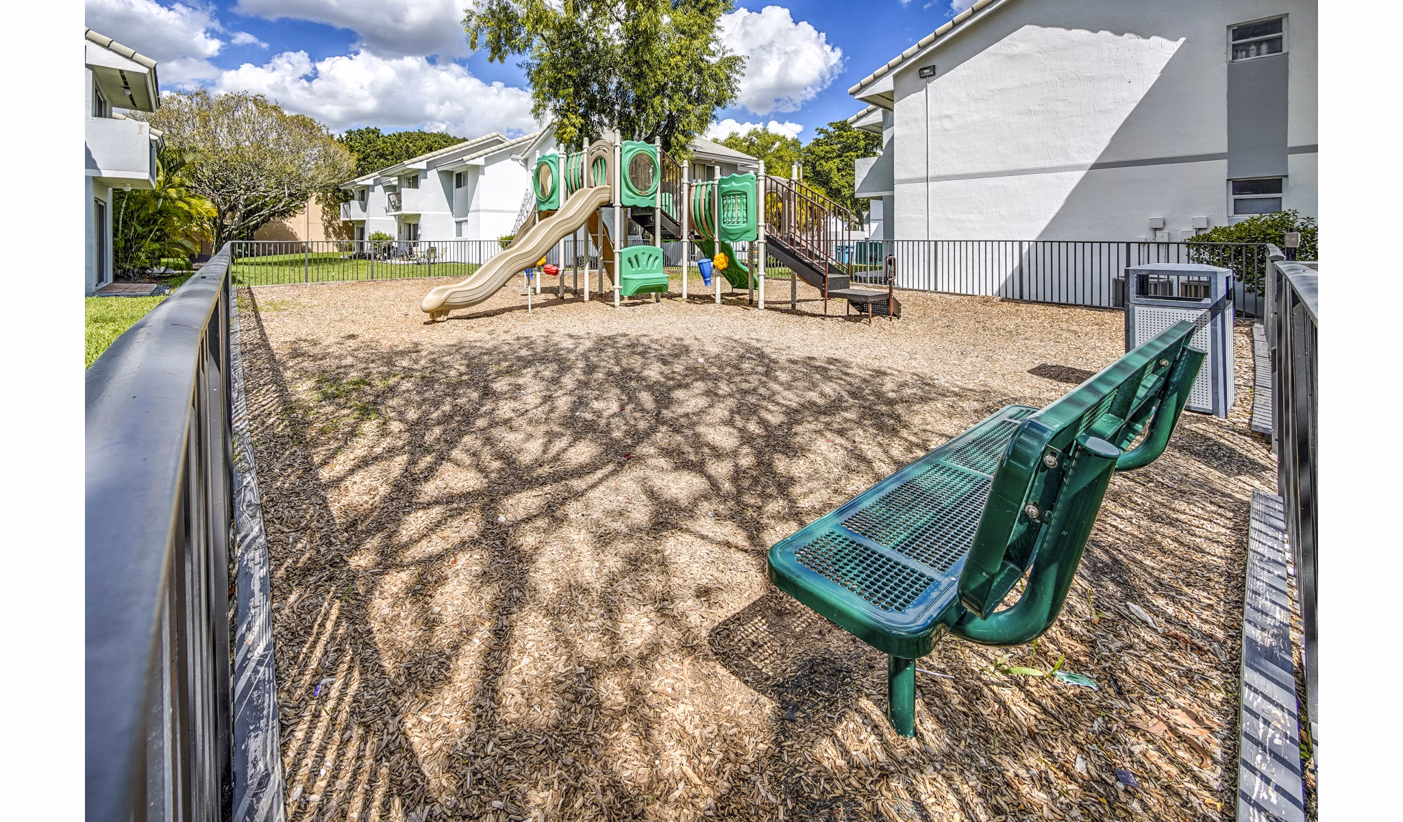 Children's playground with modern equipment at 7 West Apartments, offering a fun outdoor space for families in a vibrant residential community