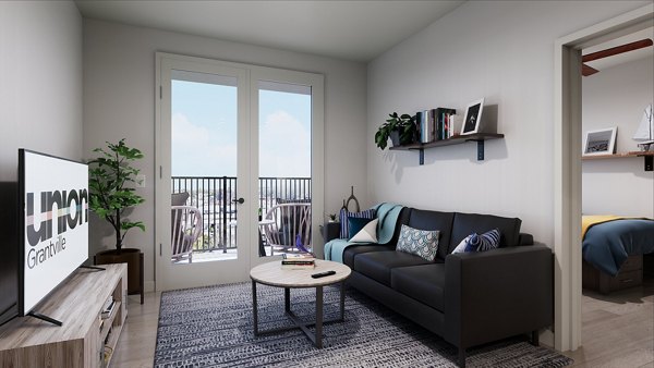 Modern living room with elegant furniture and natural light at Union Grantville Apartments, a luxury Greystar community