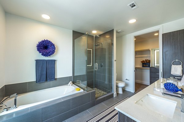 Luxurious bathroom with modern fixtures in The Travis Apartments