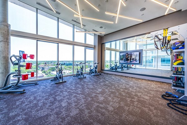 State-of-the-art fitness center featuring modern equipment at The Travis Apartments
