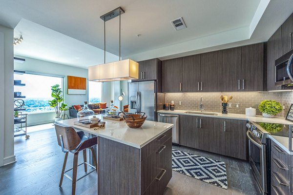 Modern kitchen with stainless steel appliances at The Travis Apartments