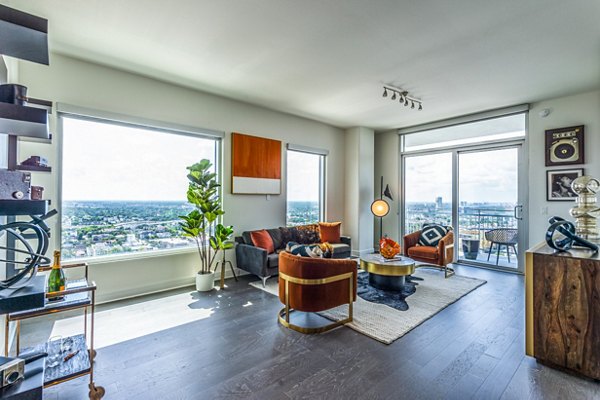 Spacious living room with modern furnishings and natural light at The Travis Apartments, a Greystar luxury community in Austin