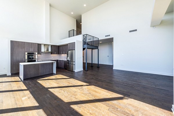 Living room with modern decor and natural light at The Travis Apartments, a Greystar luxury apartment community