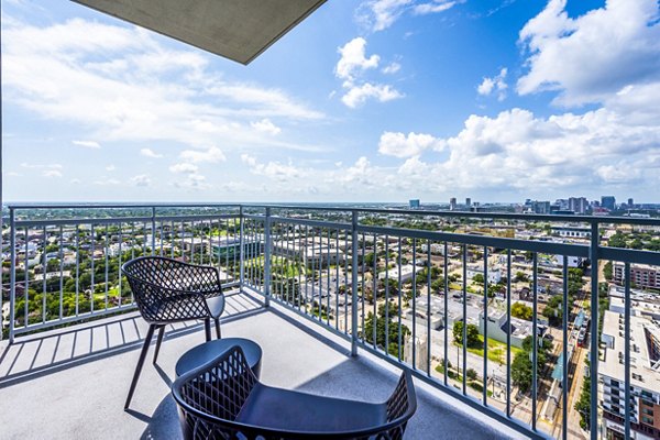 Outdoor patio with modern furniture at The Travis Apartments in Rice Village, Houston, perfect for relaxing and enjoying scenic views