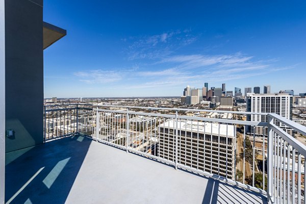 Private patio with stylish seating at The Travis Apartments, ideal for relaxation and scenic views in a luxury setting