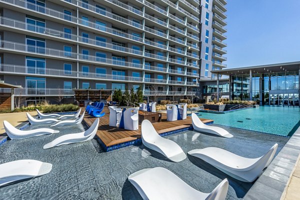 Outdoor pool and cozy fire pit at The Travis Apartments in Austin, perfect for relaxation and socializing
